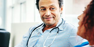 Male doctor listening to a female colleague